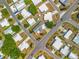 Detailed aerial view captures an organized community with tidy homes, landscaping, and orderly street layout at 1236 Elkhart Cir, Tavares, FL 32778