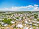 A neighborhood aerial view highlighting the community layout, tree coverage and proximity to a bay at 1236 Elkhart Cir, Tavares, FL 32778