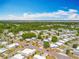 A neighborhood aerial view highlighting the community layout, tree coverage and proximity to a bay at 1236 Elkhart Cir, Tavares, FL 32778