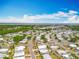 A neighborhood aerial view highlighting the community layout, tree coverage and proximity to a bay at 1236 Elkhart Cir, Tavares, FL 32778
