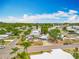 Beautiful aerial view of homes in a peaceful neighborhood with well-maintained streets and tropical landscaping at 1236 Elkhart Cir, Tavares, FL 32778