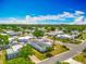 Overhead shot showcases a tranquil residential area with tidy homes and green spaces under a bright blue sky at 1236 Elkhart Cir, Tavares, FL 32778