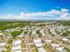 A neighborhood aerial view highlighting the community layout, tree coverage and proximity to a bay at 1236 Elkhart Cir, Tavares, FL 32778