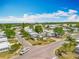 Scenic aerial view of a vibrant residential community with manicured lawns and lush green trees under a blue sky at 1236 Elkhart Cir, Tavares, FL 32778