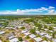 An aerial view of a well-maintained residential community near a lake, featuring numerous homes and lush green landscaping at 1236 Elkhart Cir, Tavares, FL 32778