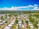 Scenic aerial view of a residential community nestled amongst trees near a lake, showcasing the neighborhood's layout and natural beauty at 1236 Elkhart Cir, Tavares, FL 32778