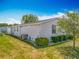 Well-manicured backyard showcasing lush green grass, landscaping, and the home's exterior at 1236 Elkhart Cir, Tavares, FL 32778