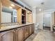 Well-lit bathroom with a double sink vanity, tiled flooring, and a separate toilet area at 1236 Elkhart Cir, Tavares, FL 32778