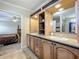 Bathroom featuring double sinks, a granite countertop, and ample cabinet storage space at 1236 Elkhart Cir, Tavares, FL 32778