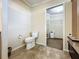 Bathroom with a toilet, tiled floor, and vanity with granite countertop in background at 1236 Elkhart Cir, Tavares, FL 32778