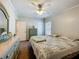 Bright bedroom featuring a ceiling fan, neutral walls, and pastel colored dresser at 1236 Elkhart Cir, Tavares, FL 32778