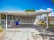 Attached carport with ample parking space and a door that leads to a screened-in patio at 1236 Elkhart Cir, Tavares, FL 32778
