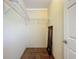 This walk-in closet has wire shelving for storage and organization. There is an interior door at 1236 Elkhart Cir, Tavares, FL 32778