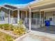 Inviting home exterior with covered porch, landscaping, and attractive neutral color scheme at 1236 Elkhart Cir, Tavares, FL 32778