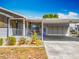 Attractive single-story home showcasing a covered carport and well-maintained landscaping at 1236 Elkhart Cir, Tavares, FL 32778