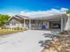 Charming single-story home featuring a covered carport and a well-manicured lawn on a sunny day at 1236 Elkhart Cir, Tavares, FL 32778