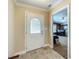 Foyer showcasing decorative front door and tile flooring, leading to entertainment area at 1236 Elkhart Cir, Tavares, FL 32778