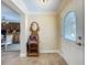 Foyer featuring tile flooring and decorative mirror with views into dining room at 1236 Elkhart Cir, Tavares, FL 32778