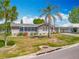 Charming single-story home with well-manicured lawn and mature palm trees at 1236 Elkhart Cir, Tavares, FL 32778