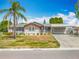 Lovely single-story home with carport, landscaping, and well-kept lawn at 1236 Elkhart Cir, Tavares, FL 32778