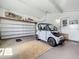 Spacious garage with ample storage and an electric car at 1236 Elkhart Cir, Tavares, FL 32778