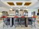 Kitchen island with bar stool seating and views of the cabinets and appliances at 1236 Elkhart Cir, Tavares, FL 32778