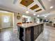 Bright kitchen with a large island, pendant lighting, and views of the living area at 1236 Elkhart Cir, Tavares, FL 32778