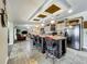 Open kitchen with a center island and breakfast bar, open to the living room at 1236 Elkhart Cir, Tavares, FL 32778