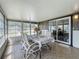 Enclosed lanai with large windows and a dining area at 1236 Elkhart Cir, Tavares, FL 32778