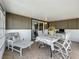 Comfortable enclosed lanai with tile flooring and ample seating at 1236 Elkhart Cir, Tavares, FL 32778