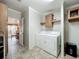 The laundry room features a washer, dryer and storage cabinets at 1236 Elkhart Cir, Tavares, FL 32778
