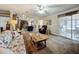 Spacious living room with sliding glass doors, an open kitchen, and a comfortable seating arrangement at 1236 Elkhart Cir, Tavares, FL 32778