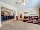 Open-concept living room with view into the kitchen and comfortable leather seating at 1236 Elkhart Cir, Tavares, FL 32778