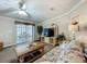Bright living room with a ceiling fan, floral sofa, and sliding glass doors leading to the patio at 1236 Elkhart Cir, Tavares, FL 32778
