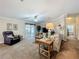 Spacious living room with plush carpeting, ceiling fan, and sliding glass doors to the patio at 1236 Elkhart Cir, Tavares, FL 32778
