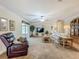 Comfortable living room boasts a leather recliner, floral sofa, and large windows at 1236 Elkhart Cir, Tavares, FL 32778