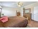 Spacious main bedroom featuring wood furnishings and a ceiling fan for added comfort at 1236 Elkhart Cir, Tavares, FL 32778