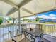 Inviting covered porch with outdoor seating, perfect for relaxing and enjoying the neighborhood views at 1236 Elkhart Cir, Tavares, FL 32778