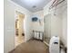 Well-organized walk-in closet with shelving and storage, plus a glimpse of the ensuite bathroom at 1236 Elkhart Cir, Tavares, FL 32778