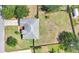 Aerial view showcases the home's layout, surrounding greenery, and expansive backyard at 13336 Biscayne Dr, Grand Island, FL 32735