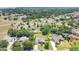 Aerial view showcasing a neighborhood with mature trees and well-maintained lawns at 13336 Biscayne Dr, Grand Island, FL 32735