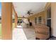 Covered patio area featuring ceiling fans, seating, and outdoor cooking space with BBQ at 13336 Biscayne Dr, Grand Island, FL 32735