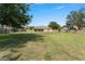 Large backyard enclosed by a wood fence, featuring a covered patio for outdoor enjoyment at 13336 Biscayne Dr, Grand Island, FL 32735