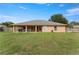 Large backyard featuring a covered patio perfect for outdoor relaxation and entertainment at 13336 Biscayne Dr, Grand Island, FL 32735