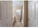 Well-lit bathroom featuring a shower-tub combo and neutral-toned walls at 13336 Biscayne Dr, Grand Island, FL 32735