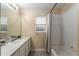 Bright bathroom with a large mirror, vanity, and a shower-tub combination at 13336 Biscayne Dr, Grand Island, FL 32735