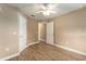 Spacious bedroom with wood-look floors and a ceiling fan at 13336 Biscayne Dr, Grand Island, FL 32735