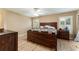 Cozy bedroom with wood flooring, a ceiling fan, and natural light from shuttered windows at 13336 Biscayne Dr, Grand Island, FL 32735