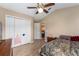 Cozy bedroom with wood floors, standard closet, and view to the hallway at 13336 Biscayne Dr, Grand Island, FL 32735