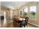 Open-plan dining room with tile floors, large windows, and a chandelier for elegant dining at 13336 Biscayne Dr, Grand Island, FL 32735